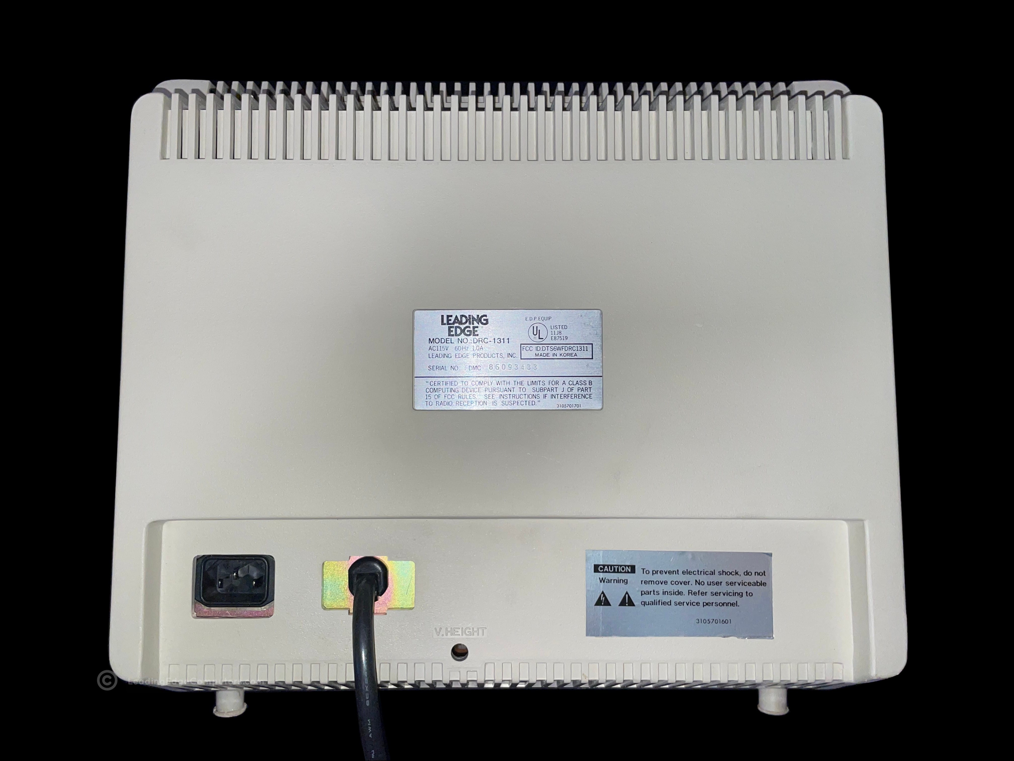 A view of the rear of the DRC-1311 monitor showing the label and cables