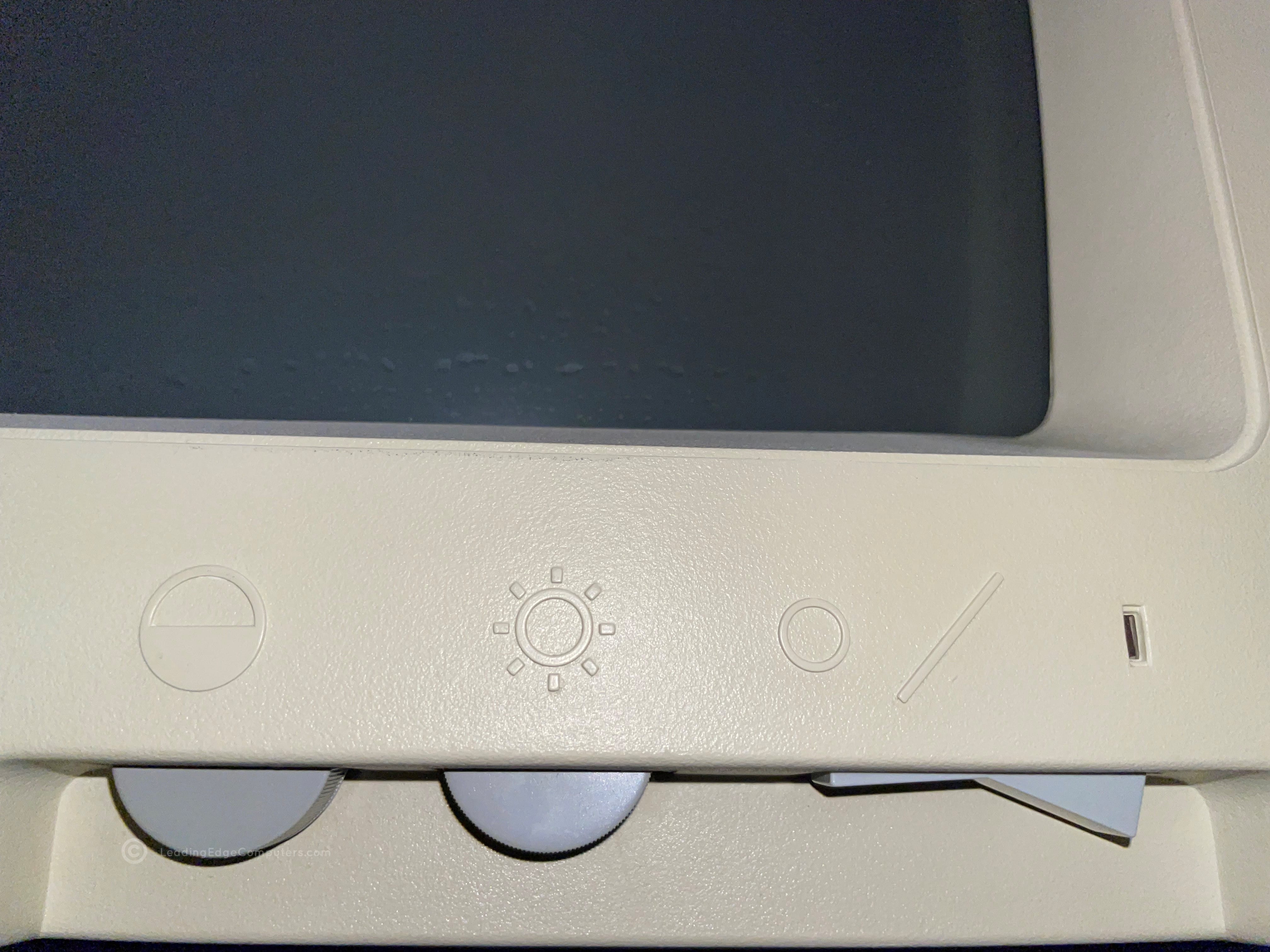 A close-up view of the DRC-1311 monitor's brightness, contrast, and power switch