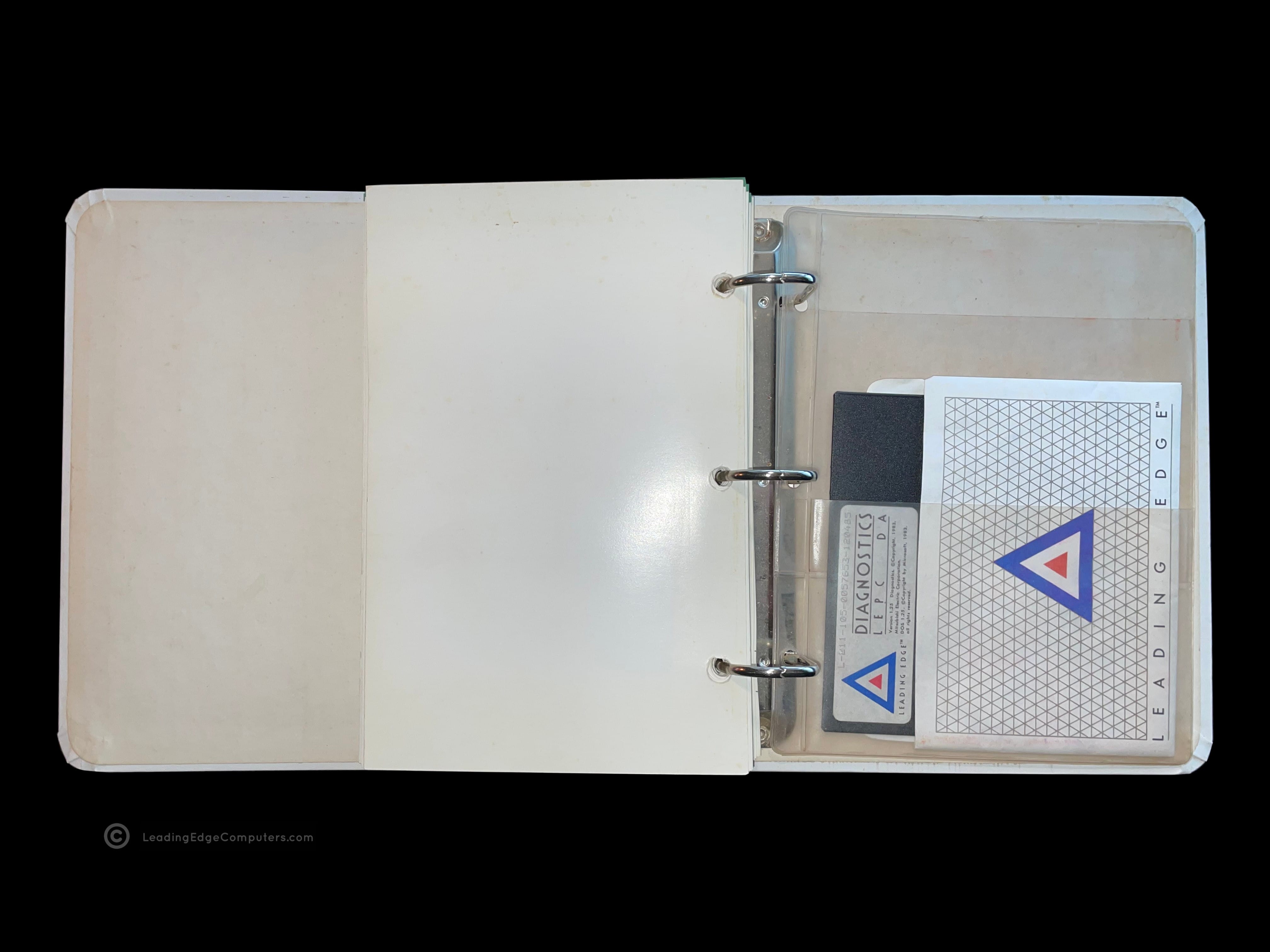 The back of an opened Technical Reference Manual showing the plastic sleeve for housing the diagnostics disk